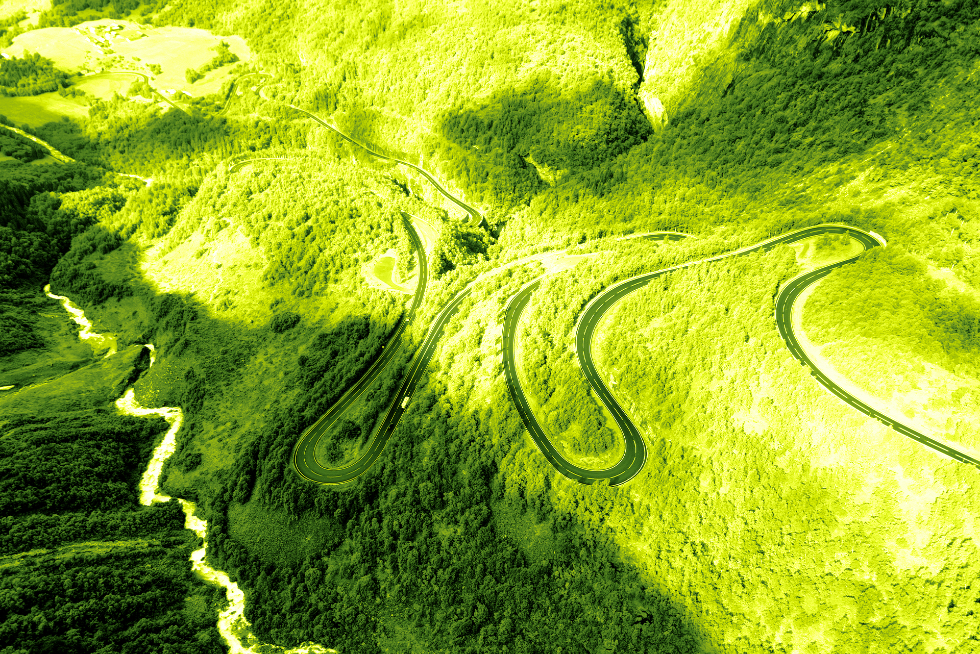 Image of long bendy road in green colour