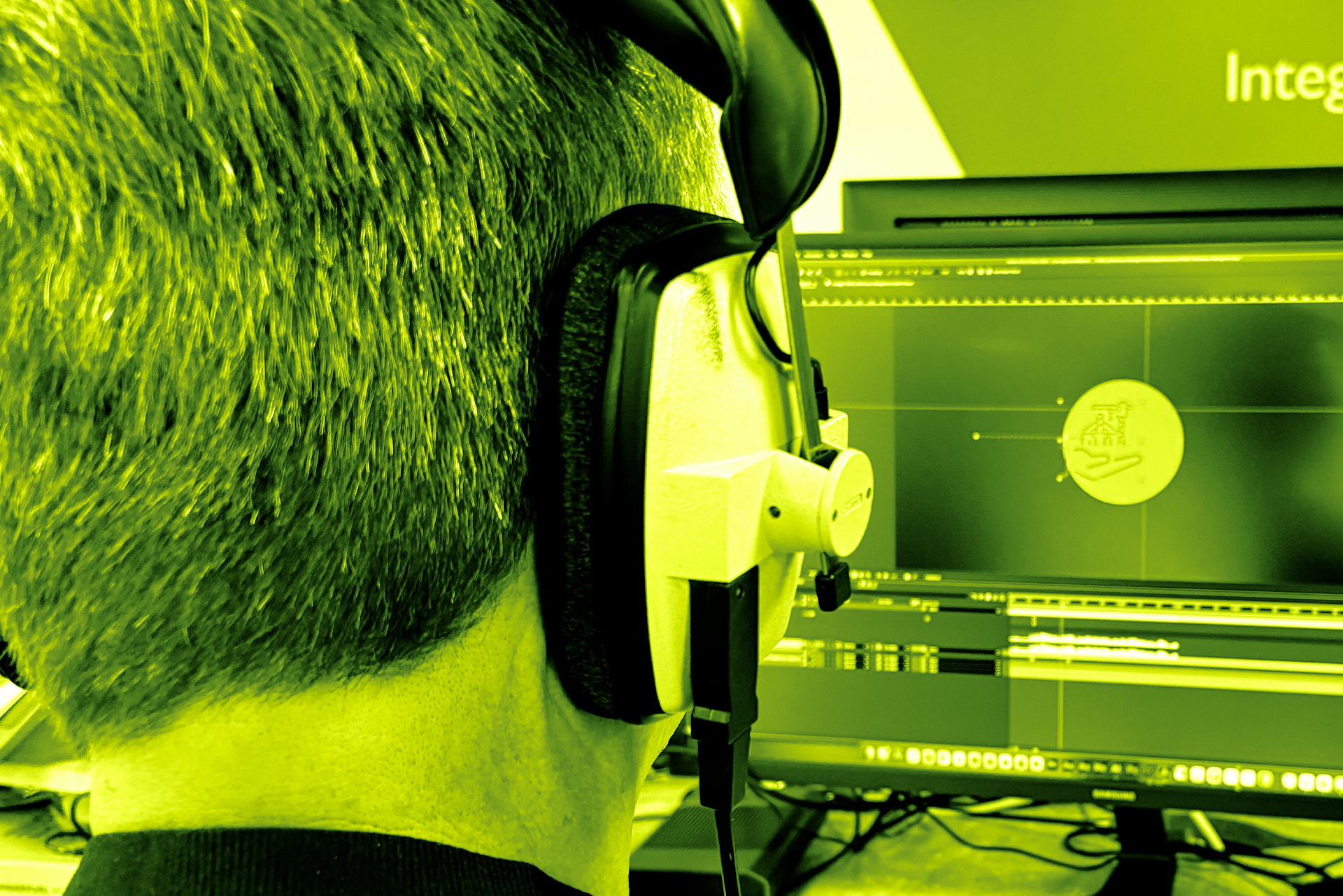 Creative designer in front of a laptop wearing headphones